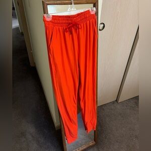 LA12ST orange super soft joggers, size M.